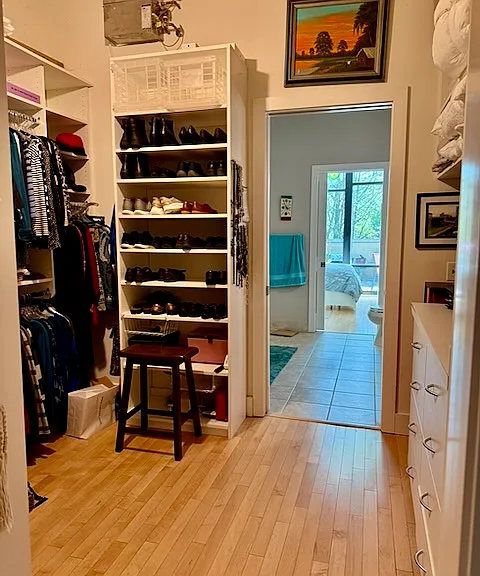 Closet/dressing room with extensive built-in drawers and shelves.