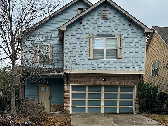 Front of house, 2 car garage.