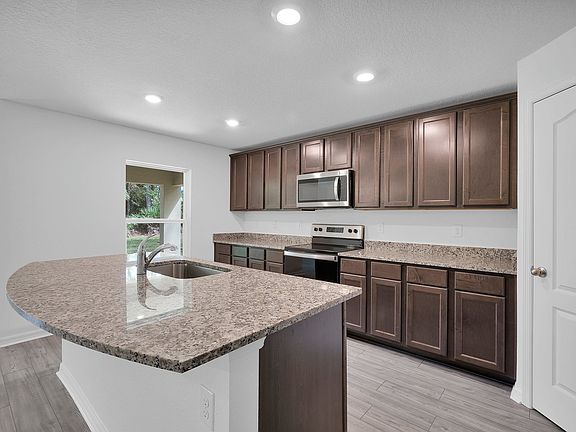 Gorgeous upper-wood cabinets are an eye-catching feature in the heart of the home