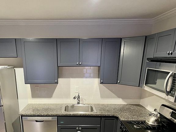 Fully-equipped kitchen boasts stainless appliances and lots of cabinet space