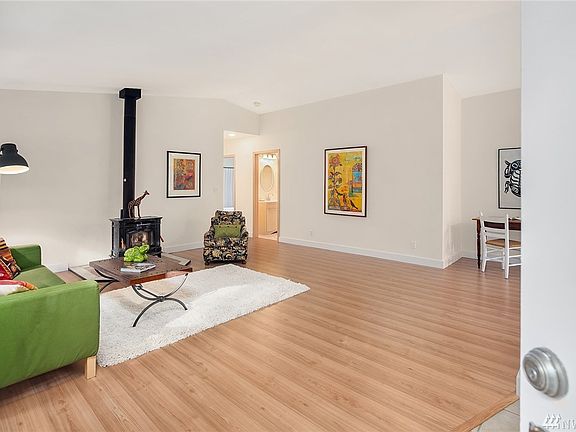Spacious and airy living room with wood-burning stove greets you just inside the front door. 