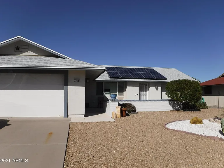 Desert landscaping with citrus trees in back yard.
