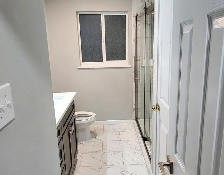 Guest bathroom with rain water shower and new appliances.