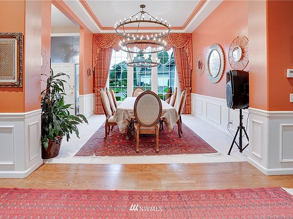Large formal dining room with picture framing, coffered ceiling, picturesque window and gorgeous hanging light!