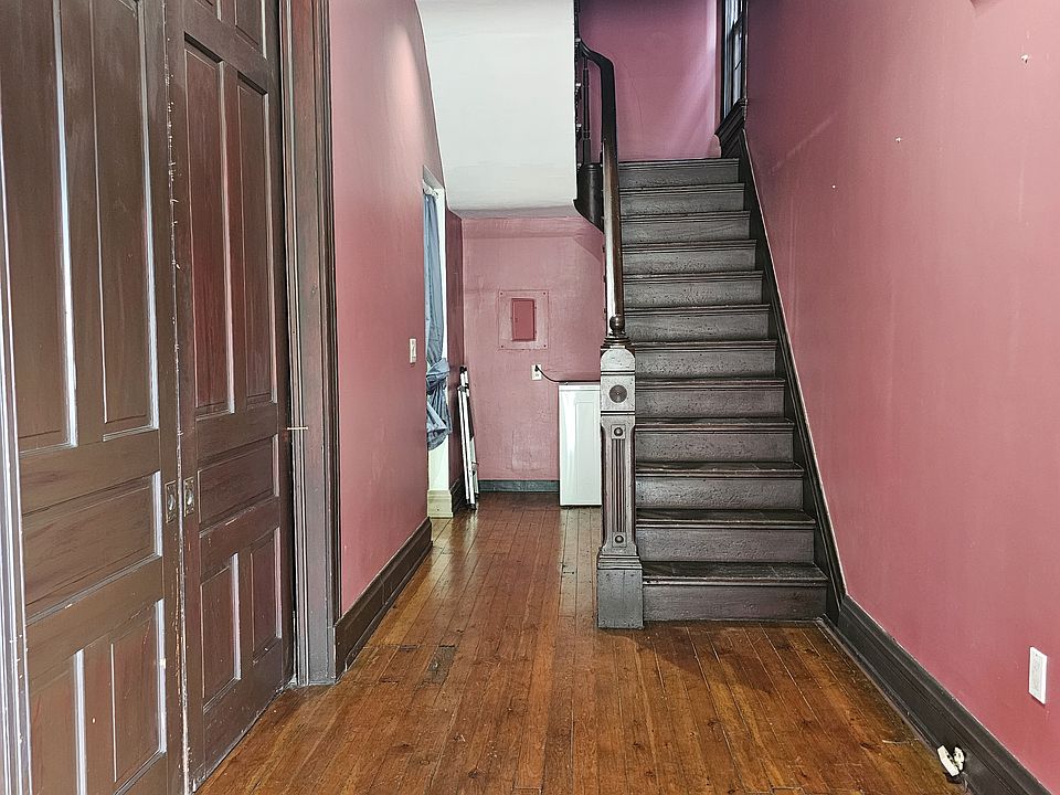 Front entrance with historic stairway storage. (it no longer opens to the second) floor