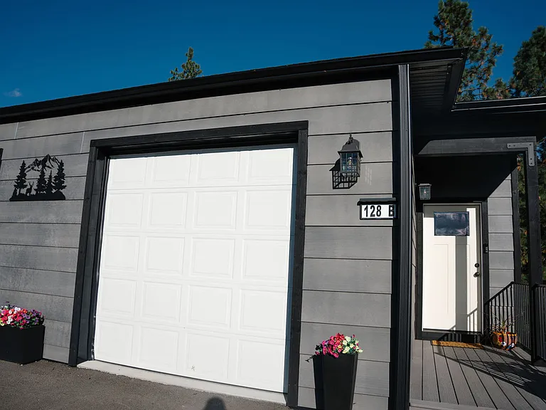 Single car attached garage in a shared driveway with one other unit fitting 4 cars
