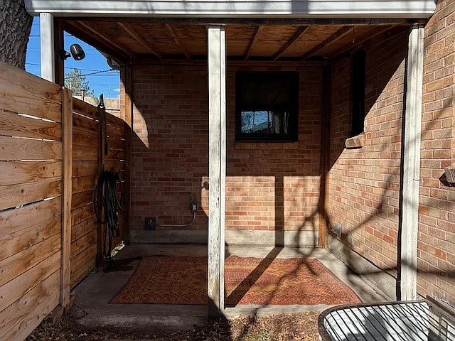Back covered patio, hose, outdoor spigot and outdoor electrical outlet.