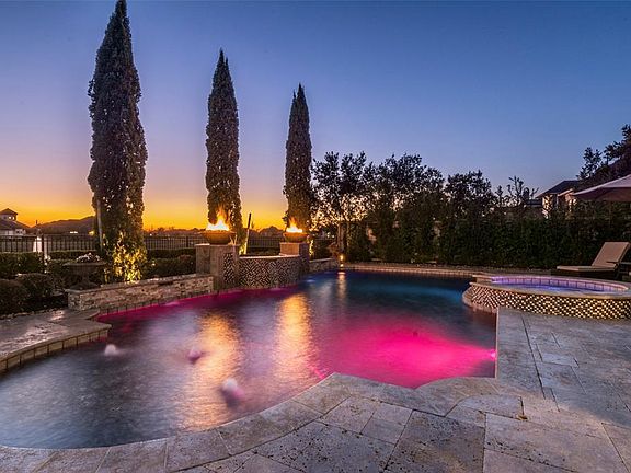 The pool can be heated and chilled. It offers wonderful lighting in the pool and spa plus water features and fire bowls with manicured landscaping behind them. Note the evenings that will offer a sunset backdrop.... outstanding.