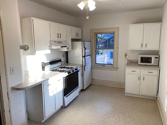 The kitchen has south and west facing windows and a door onto the balcony.