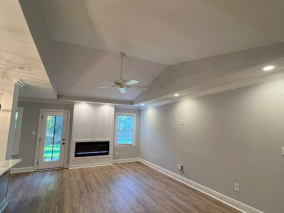 Living room with vaulted ceiling, view from front door entrance