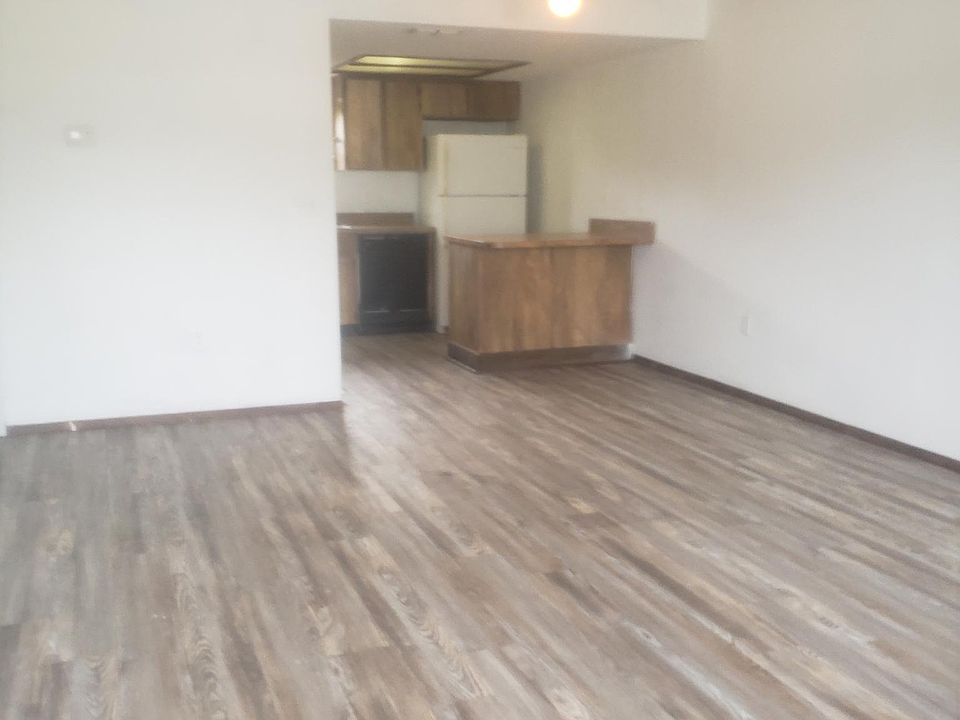Living room and breakfast bar view w/ kitchen