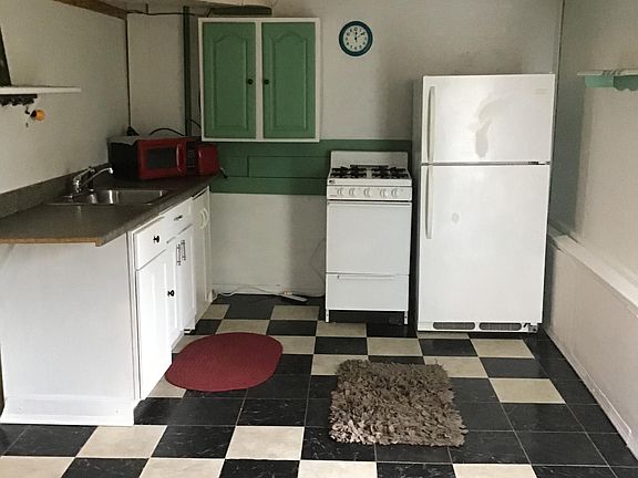 Country kitchen with gas stove, refrigerator and lots of storage.