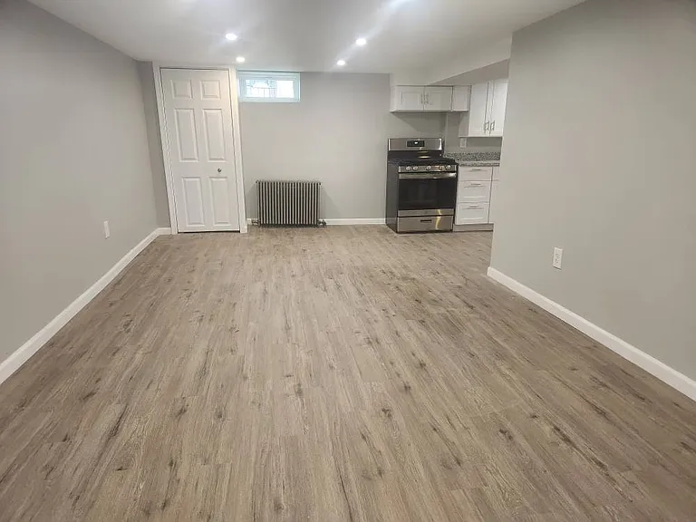 Family room, dining area, kitchen, and laundry/storage room in lower level.