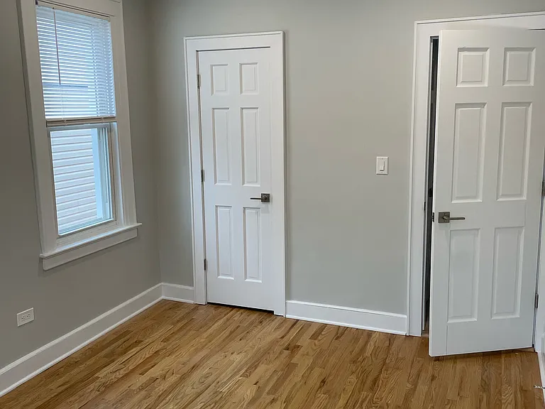 bedroom with closet next to window
