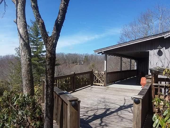 covered porch with 4 Troutman rocking chairs as well as sun porch. Views of Grandfather mtn, Hawkesnest, Beech and Sugar