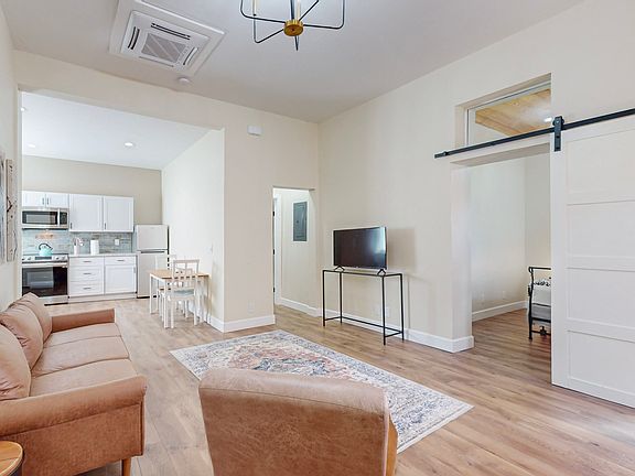 Stunning high ceilings, quartz countertops, stainless appliances and new heat & AC