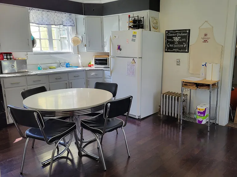 BIG Eat in Kitchen. Sunny. New Sept '24 gas stove. Windows. Washer and Dryer. French Fridge. Granite counters. 1920 Barn Find Farm Sink.. Dark Hardwoods. Leads to covered patio overlooks big grassy back yard with mature trees. Fenced patio-small yard.