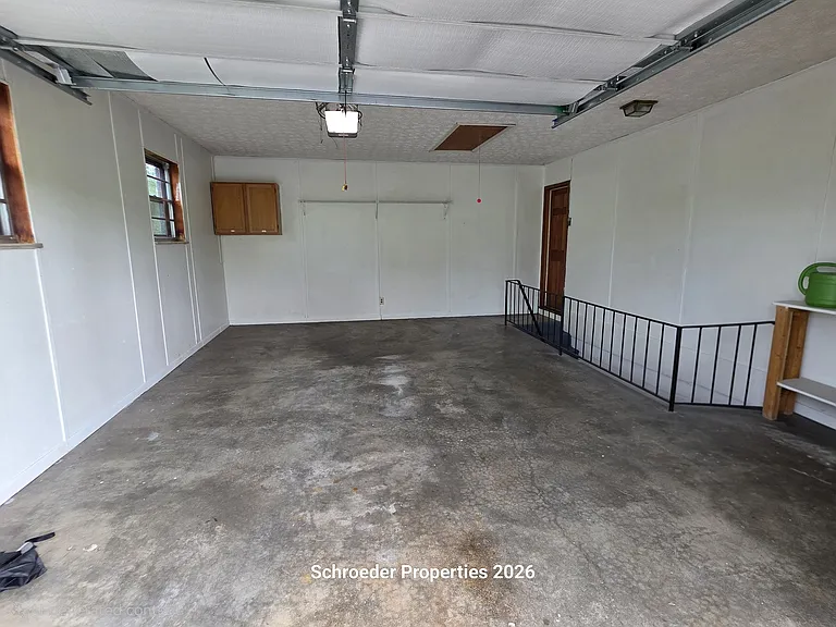Garage with stairs to basement
