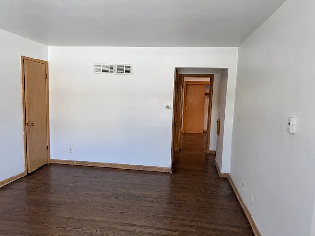 Living room, looking at hallway: linen closet to the left, bedroom 1 after linen closet on left, bedroom 2 directly ahead, and bathroom to right.