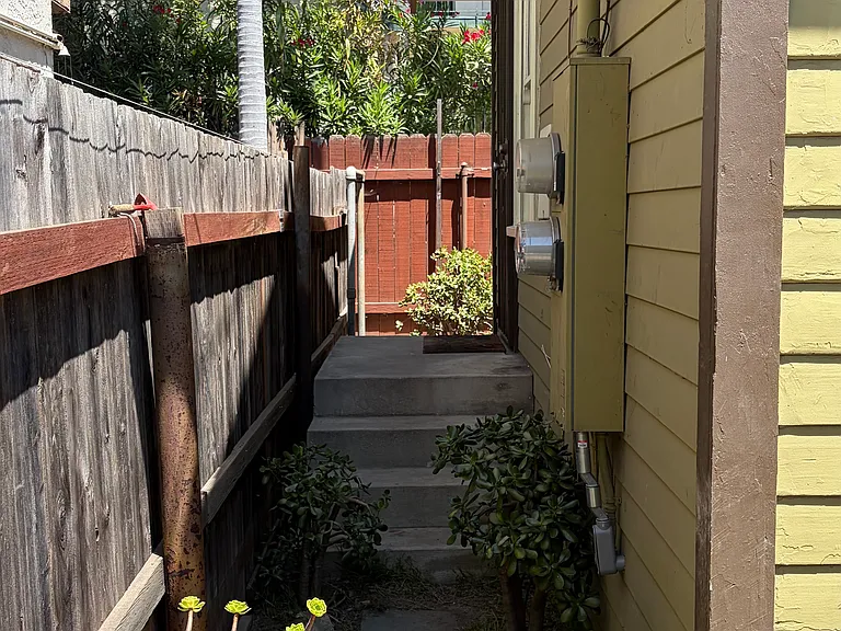 Side yard w steps to back door.