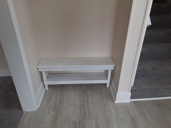 Inside foyer has a built in bench to sit down and take your shoes off. To right upstairs, to left the living room.