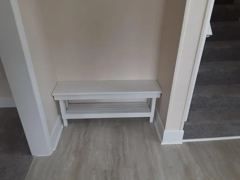 Inside foyer has a built in bench to sit down and take your shoes off. To right upstairs, to left the living room.