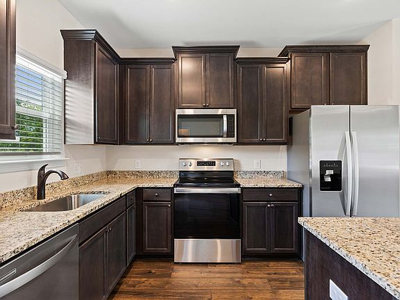 The kitchen comes fully loaded with a full suite of stainless steel appliances.