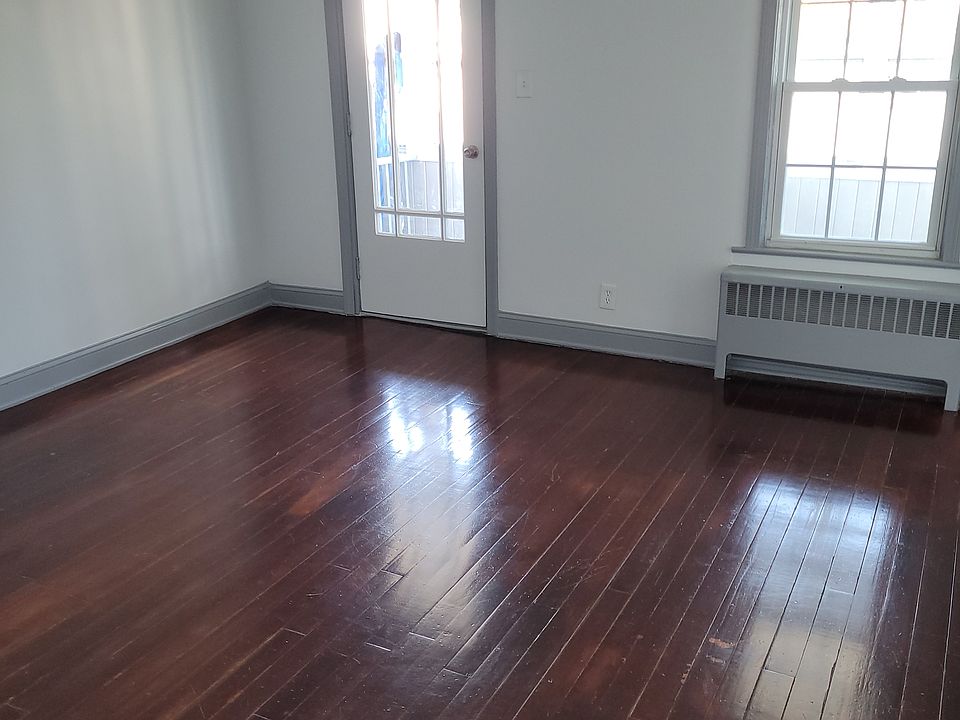 Homey Living room with wood flooring with a door leading to your enclosed balcony!