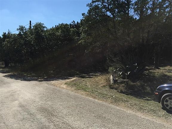 Lot on right on the other side of dirt road. Dirt road belongs to neighboring property.