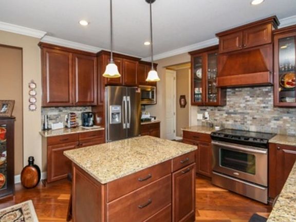 Cherry wood cabinets and under counter lighting.  Large pantry for the storage!