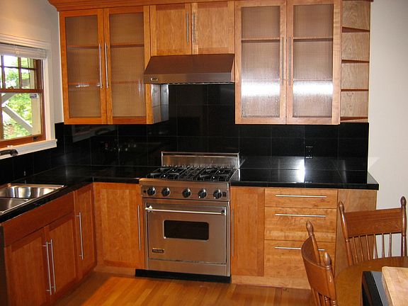 Kitchen with Viking Stove, Cherry Cabinets and Black Granite countertops