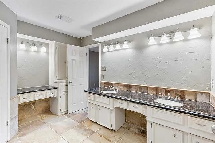 Master bathroom with vanity, dual closets, double sinks, and spa tub. Will come with mirrors for sinks and vanity.