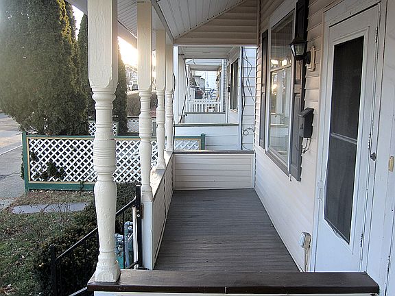 Large, full-width, roofed front porch for pleasant days and nights outside, even in the rain.