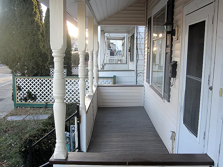 Large, full-width, roofed front porch for pleasant days and nights outside, even in the rain.