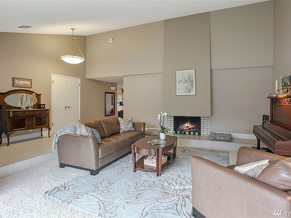 The living room also features an impressive wood-burning fireplace. The raised hearth runs the width of the fireplace wall and provides convenient extra seating too.