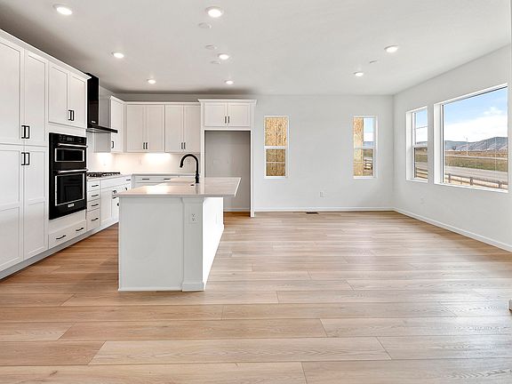 Kitchen and dining area with laminate hardwood flooring