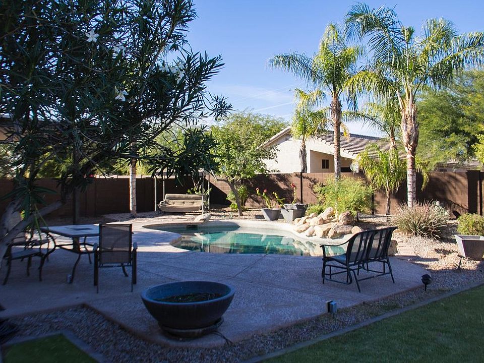 Amazing extra-large back yard with sparkling pebble-tec pool, grassy area, and raised gardens