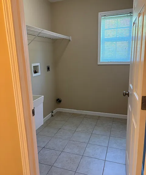 Upstairs laundry with utility sink and w/d hookups, gas or electric dryer