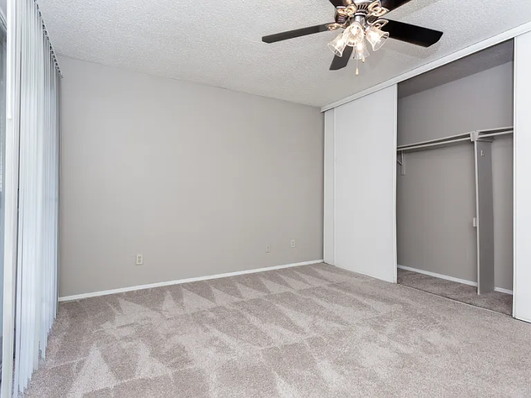 Bedroom with neutral finishes and ceiling fan