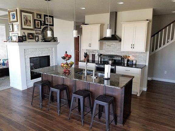 Beautiful kitchen with fireplace and golf course views. Furniture is not included.