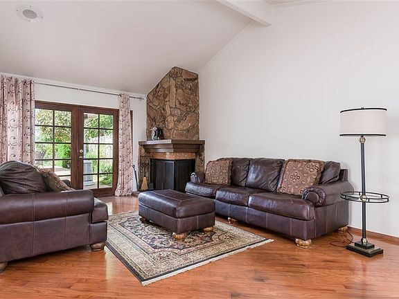 Vaulted ceiling, fireplace, french doors and hard wood flooring.
