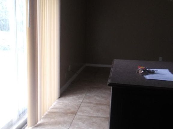 coming from kitchen to the living area with patio doors going out into the back yard