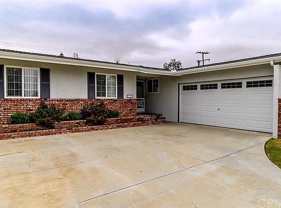 New roll-up garage. Dual-pane windows. Beautiful brick planters & front step invites you home.
