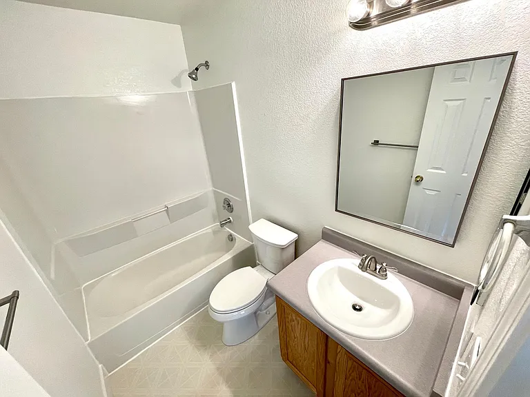 Full guest bathroom with brand new toilet, sink, and faucet