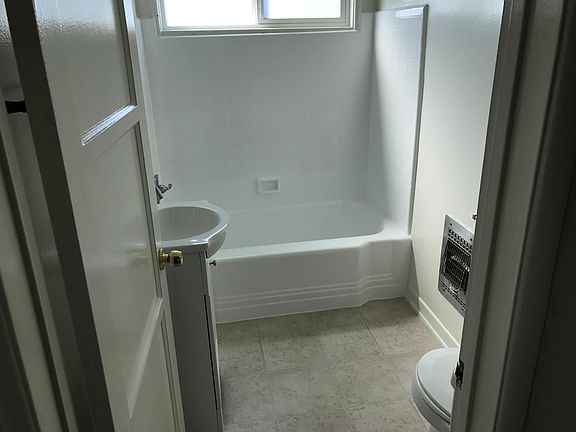 Bathroom freshened up with reglazed tub and tile, new vanity