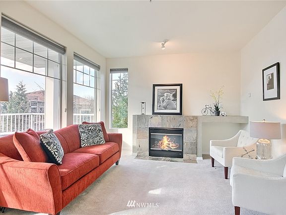 Spacious living room with lots of natural light, electric fireplace for warmth & ambiance.