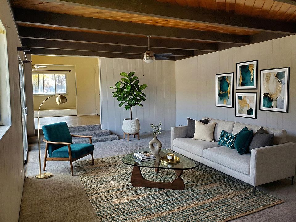 Back Living Space...Virtually Staged. Looks into front of kitchen to front Living Space.