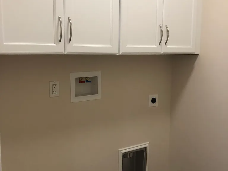 Separate Laundry room with shelving off the kitchen