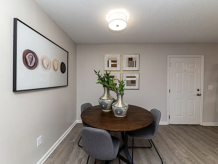 Dining area with hardwood-style flooring and overhead lighting