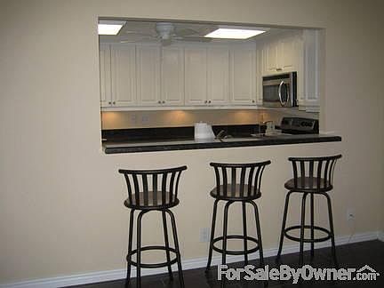 Bar to kitchen area : This is the open granite countertop bar from dining room to kitchen.